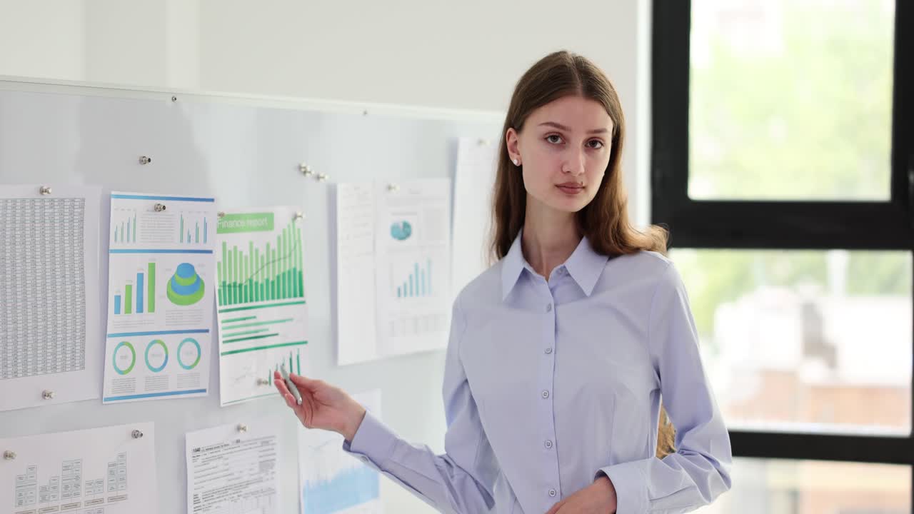 Businesswoman Presenting Financial Data on Whiteboard