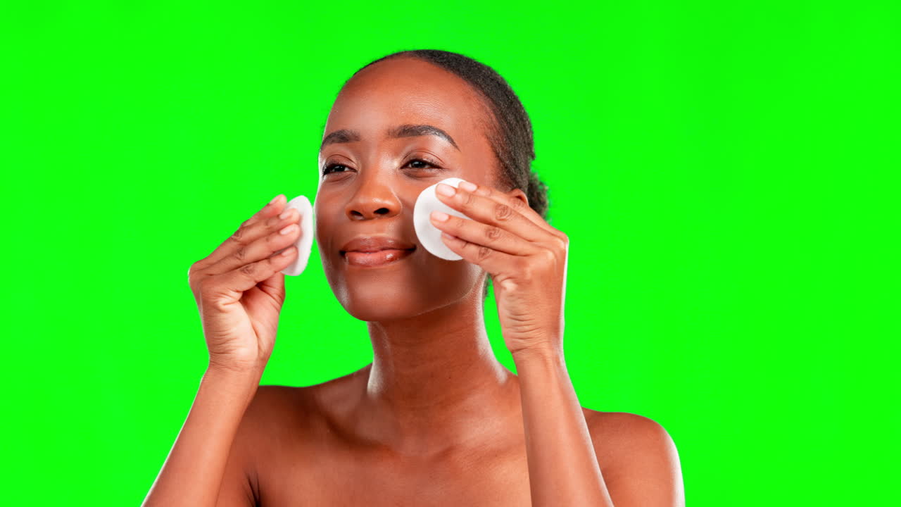 Green screen, cotton and black woman cleaning face