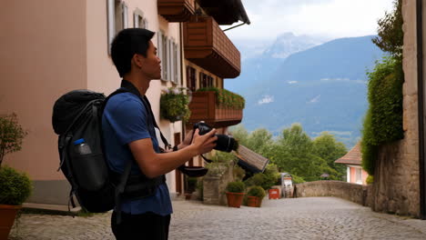 man with camera and backpack traveling in europe