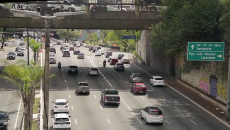 Cars-On-Avenue-Under-Bridge-in-Asian-Neighborhood-From-Brazil