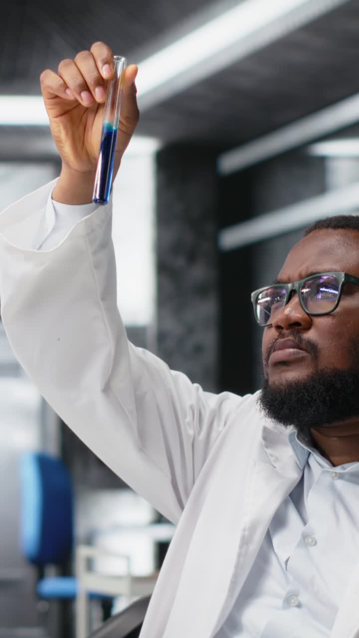 Vertical video Research facility expert typing on PC keyboard using chemical solutions