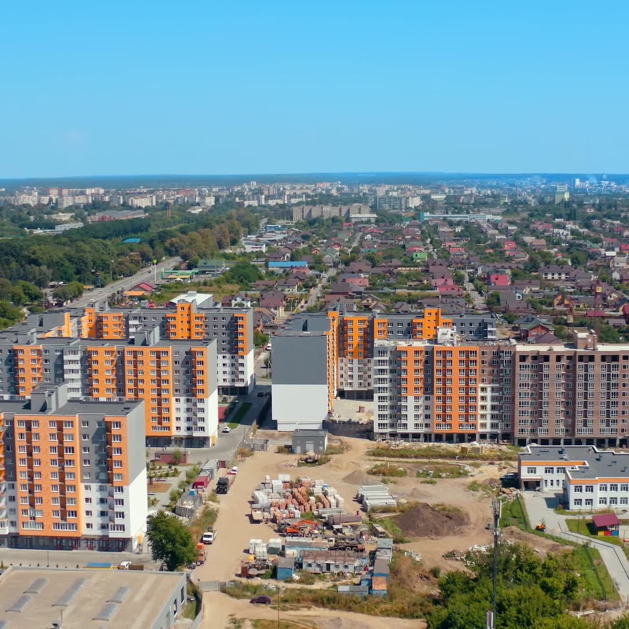 New housing apartments on urban background. Residential complex with high-rise buildings in new city area. Aerial view