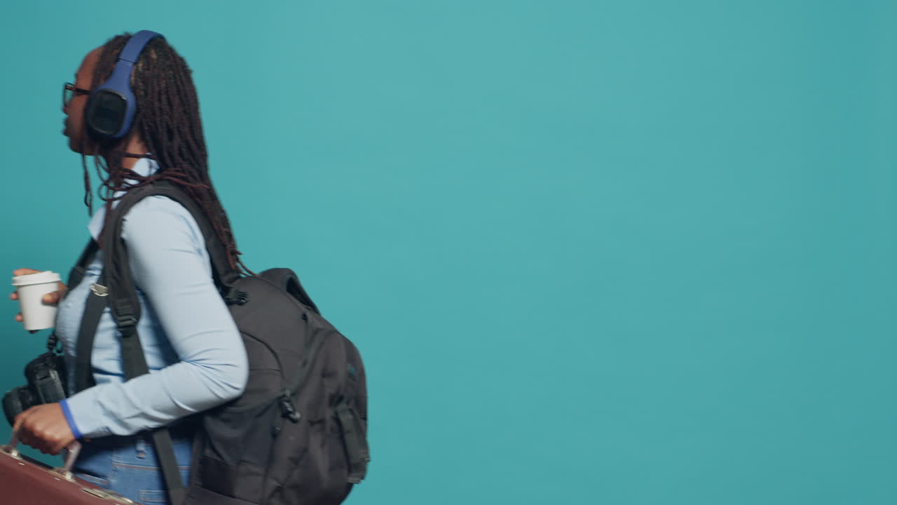 Female tourist going on holiday trip with suitcase and backpack