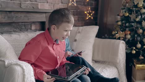 schoolboy explains fight game on tablet to younger brother