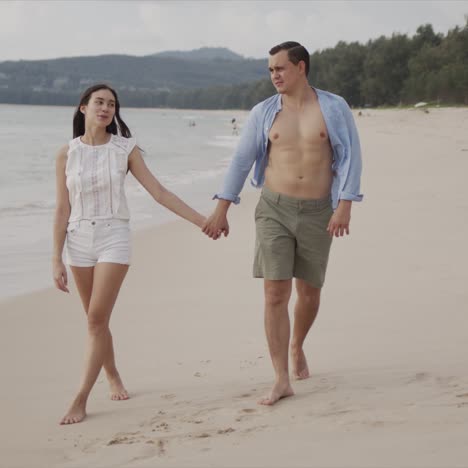 male and female lovers going on seashore while enjoying in views