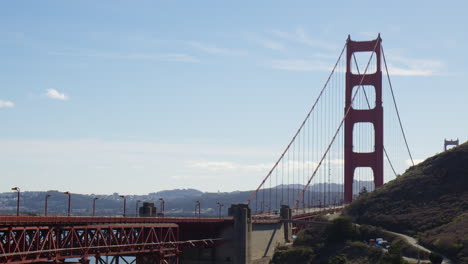 vehicles crossing the golden gate bridge during daylight hours in san francisco, california - wide shot