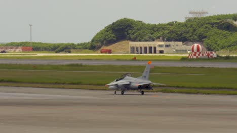 open military jet on landing track at okinawa international airport naha prefecture japan japanese america usa air force caza jet