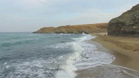 waves breaking into the sea beach