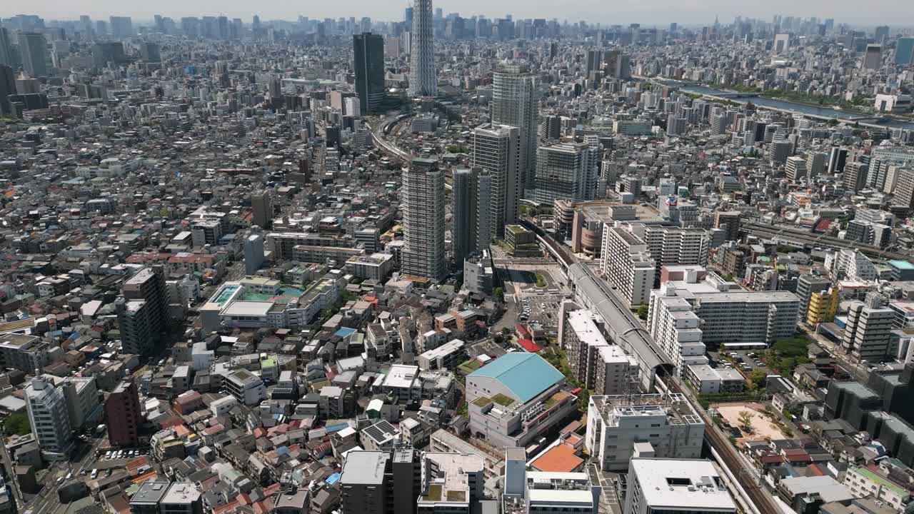 Aerial Scenic Urban Drone Footage of a neighborhood, streets and buildings in the Capital City of Tokyo, Japan on a Sunny Day