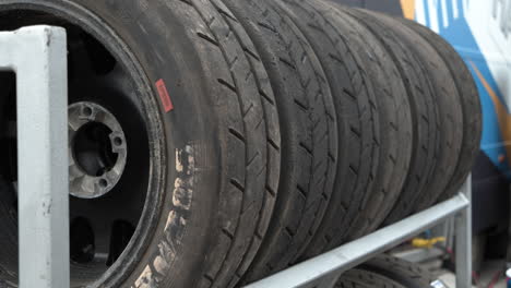 A-dolly-shot-of-a-rack-full-of-used-race-car-tires