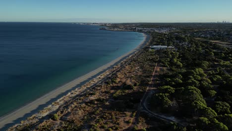 Aerial-establishing-shot-of-beautiful-Woodman-Point-Beach,Perth-City-at-sunrise,-Western-Australia