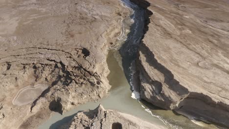 aerial view of a canyon in a dry, cracked landscape