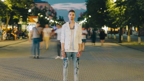 man in a white jacket on a city street at night