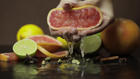 woman squeezing a fresh and juicy grapefruit with hands. fresh fruits