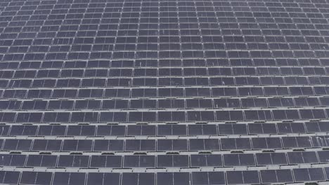 aerial view of floating solar panels in a small pond