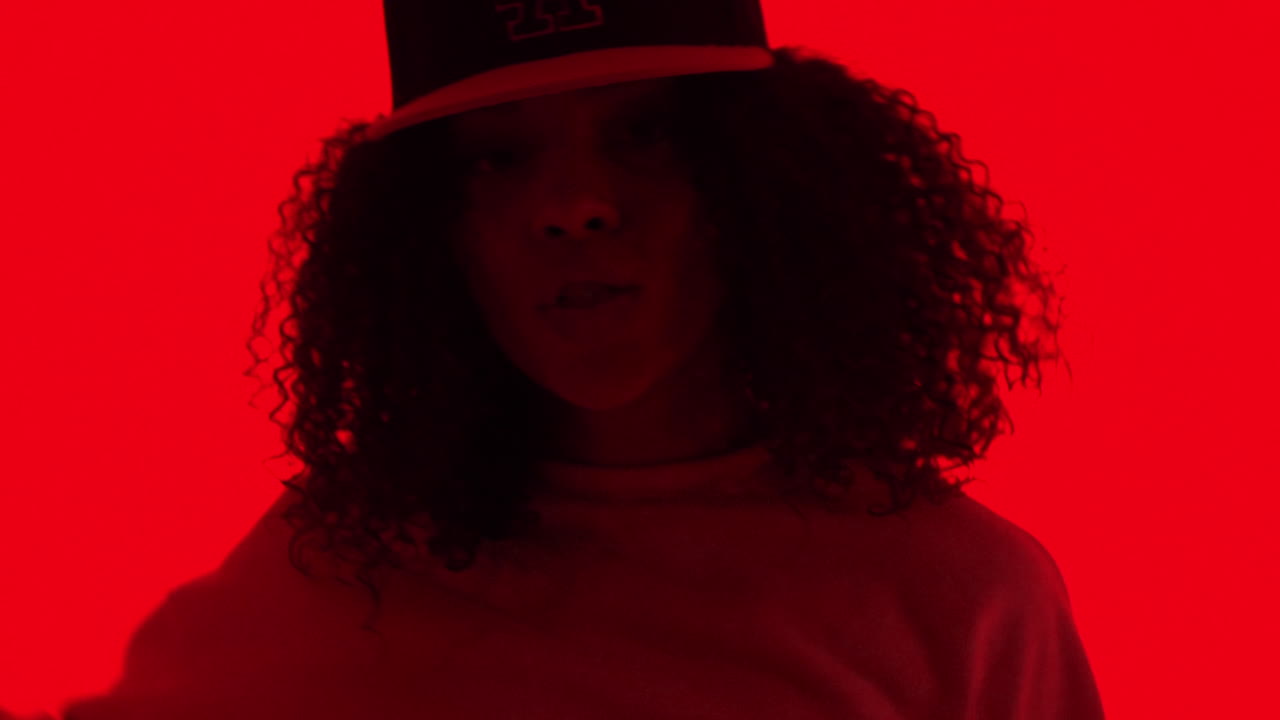 Black Woman Dancing Under Red Light