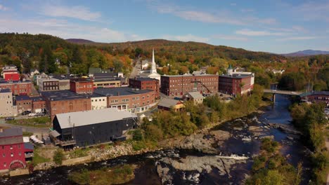 drone shot of littleton, beautiful new england town on a river during autumn