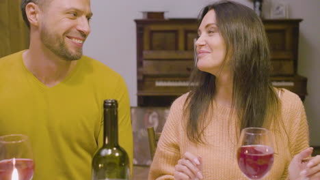 husband and wife talking during a family dinner sitting at table at home