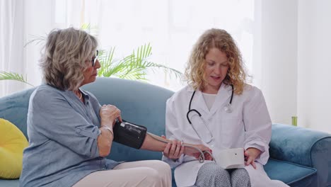 Doctor Checking Senior Woman&#039;s Blood Pressure