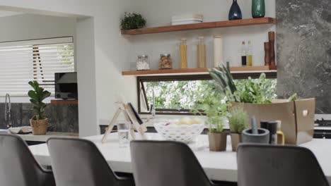 Close-up-of-fresh-vegetables-in-box-on-countertop-in-kitchen,-slow-motion