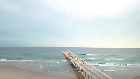 drone aerial shot over beach pier in gold coast