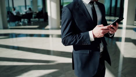 businessman using smartphone in modern office