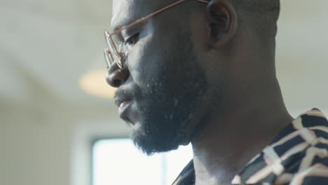 african american guy playing drums in studio