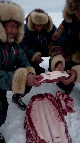 indigenous people hunting and processing whale on ice