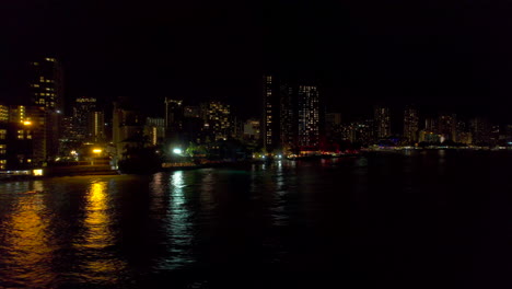 Aerial-night-view-of-Honolulu-cityscape-at-Waikiki-Beach