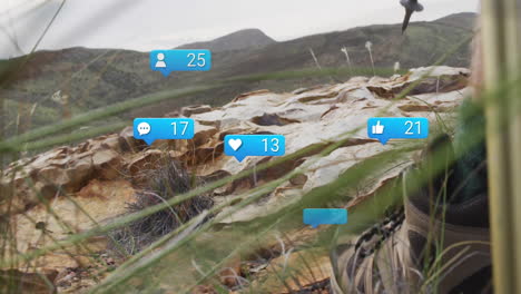 social media notifications animation over rocky landscape with grass and mountains