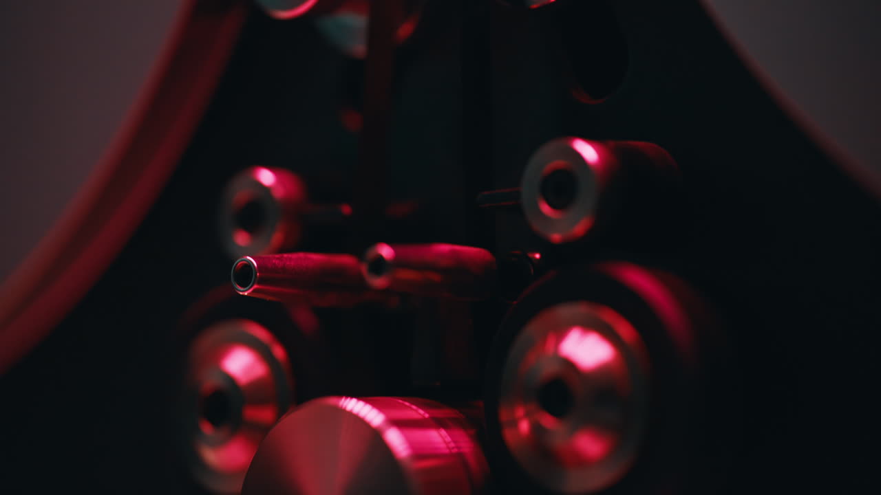 Macro view reel-to-reel device rotating tape reels at playback session closeup