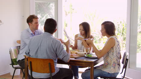 group of friends enjoying dinner party at home together