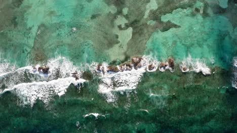 Aerial-View-Of-Ocean-Waves-Crashing-On-Rocky-Coast-Of-The-Bahamas