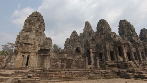 ancient structure the mystical bayon khmer temple, angkor thom, cambodia, handheld pan shot