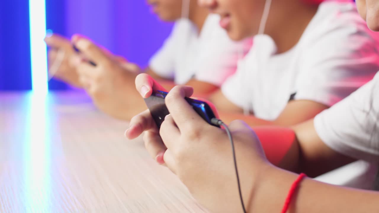 Hands Of Asian Esport Team Gamers Playing In Competitive Video Games On A Cyber Games Tournament By Mobile Phone