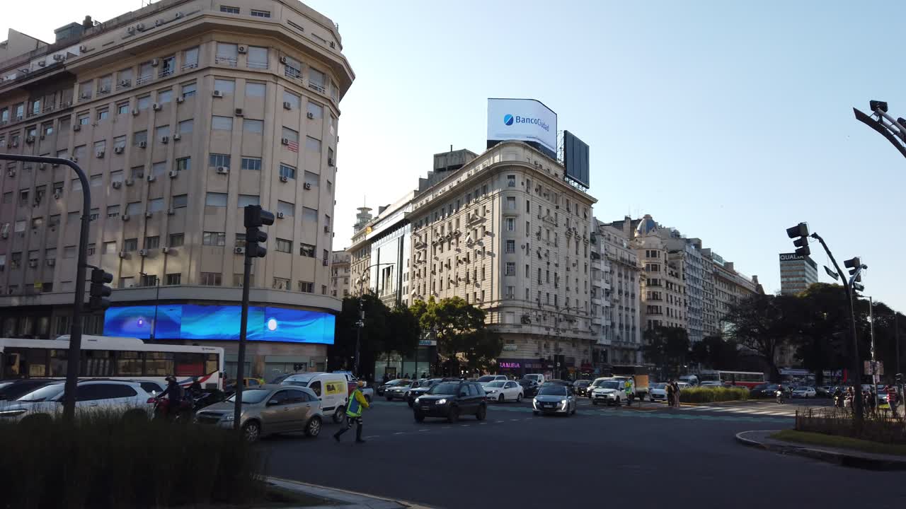 Traffic at 9 de Julio famous wide avenue panoramic in Buenos Aires city downtown bird's fly by famous center of Argentina, sunset daylight skyline