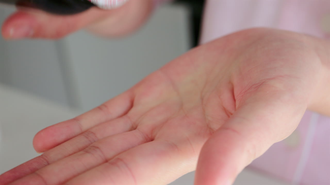Close up of a woman pouring fish oil supplements out of into her palm