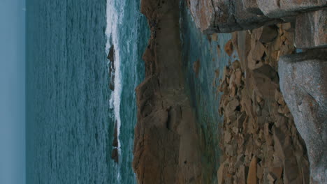 vertical video of blue atlantic ocean and cliffs of the atlantic ocean on the island île-grande in pleumeur-bodou, france cote d'amour