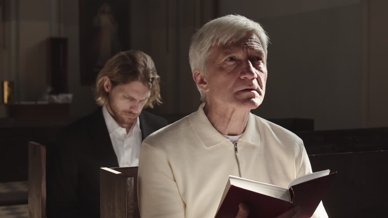 Two Male Parishioners Reading Bible in Church