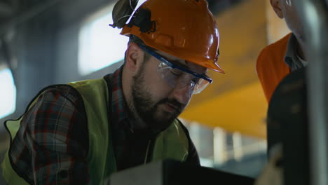 industrial workers inspecting machinery