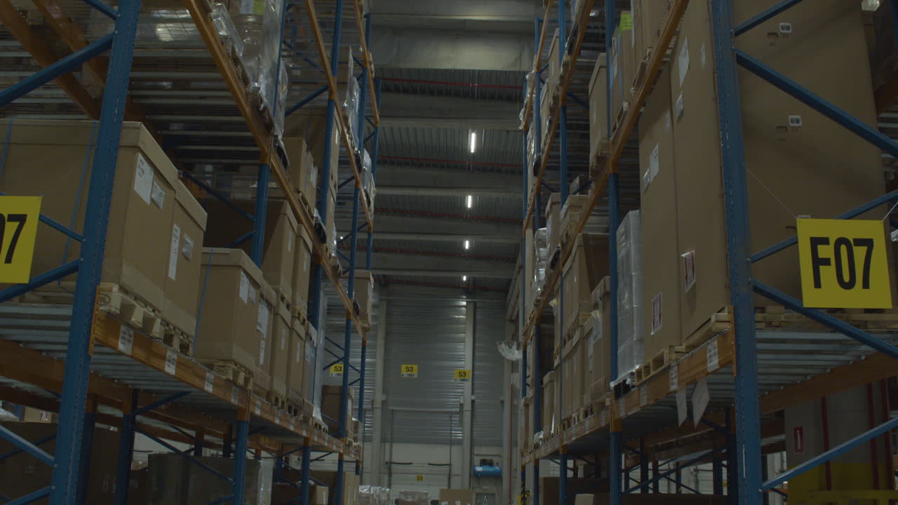 Tilt up of aisle between high racks in industrial warehouse