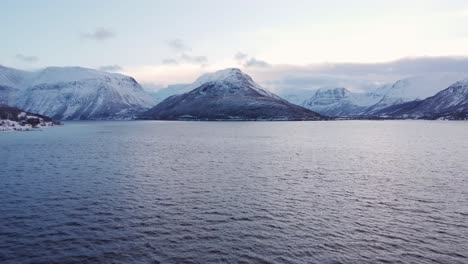 Drone-shot-of-the-Fjords-of-Norway-covered-with-snow