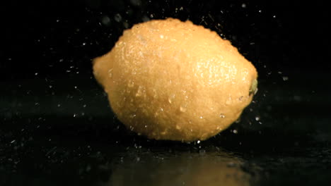 water sprayed on lemon in super slow motion