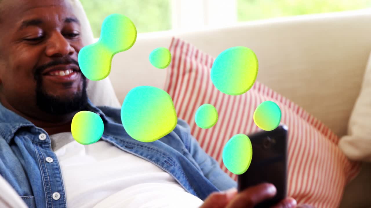 Animation of network of glowing blobs over man using smartphone