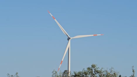 one single wind turbine against blue sky