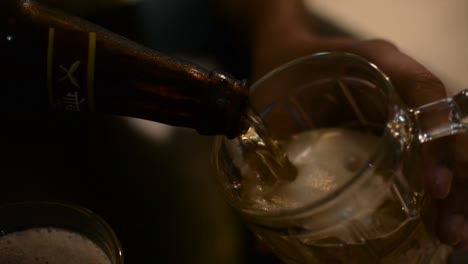 pouring a glass of beer from a bottle