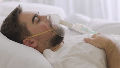 Sick-Man-Lying-On-Bed-Taking-His-Oxygen-Mask-Off-And-Coughing-1