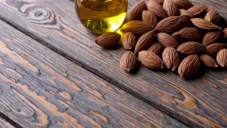 almonds and almond oil on wooden table