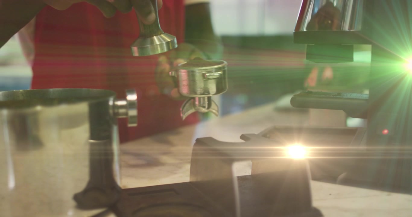 Animation of light spots over man preparing coffee in cafe
