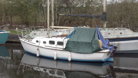 small sailboats floating on rural countryside canal marina